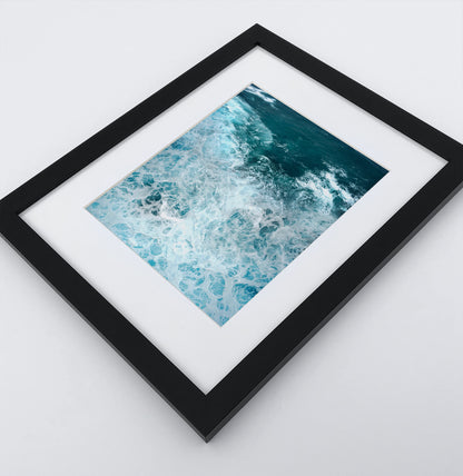 A detailed arial ocean waves photo in a dark frame