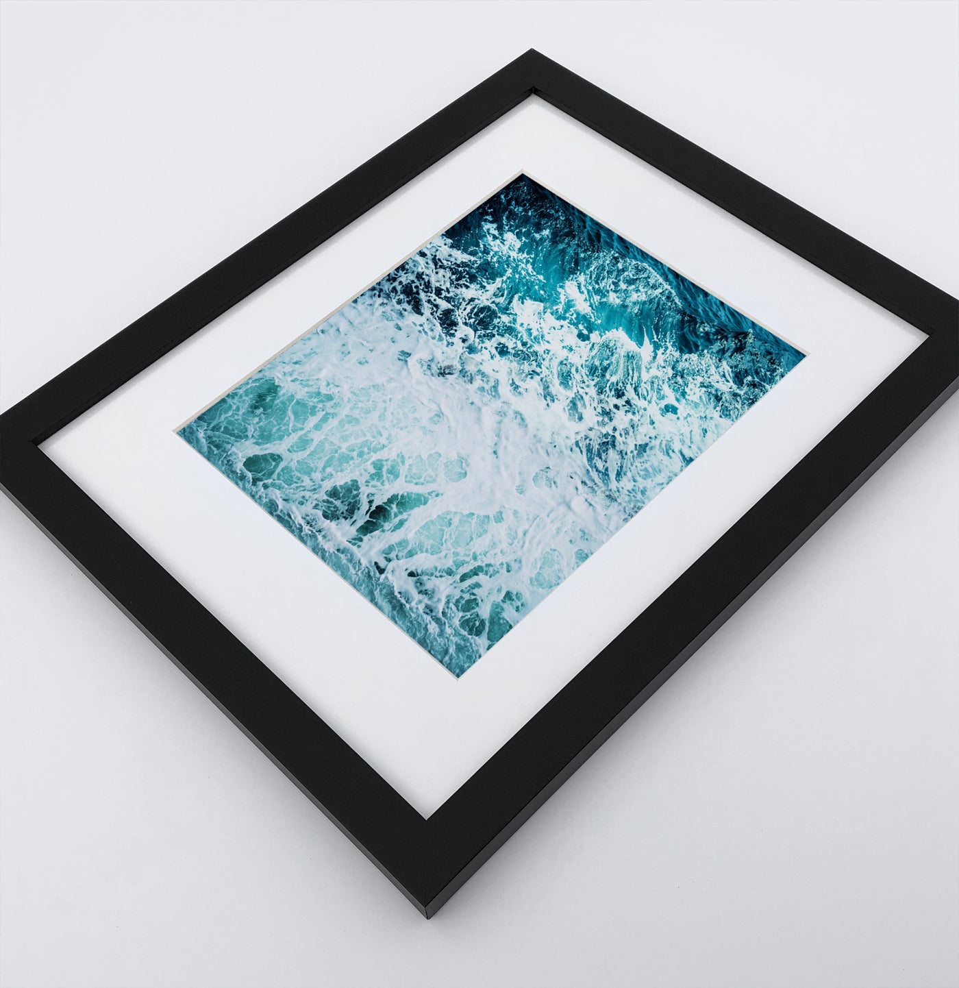 A detailed arial ocean waves photo in a dark frame