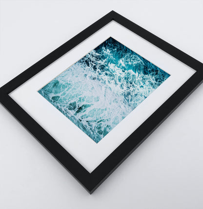 A detailed arial ocean waves photo in a dark frame