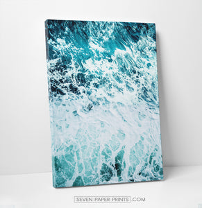 A stretched canvas of white sea waves and foam on dark blue ocean