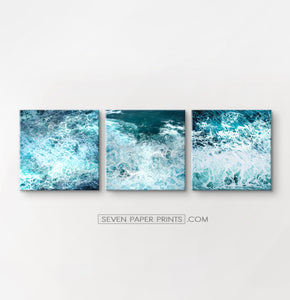 3 stretched canvases of white sea waves and foam on square frames.