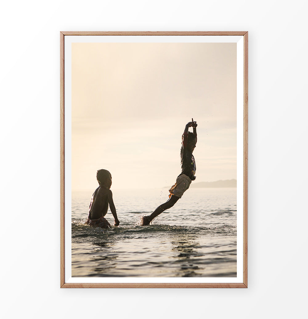 Boys jumping into the sea, summer fun photograph